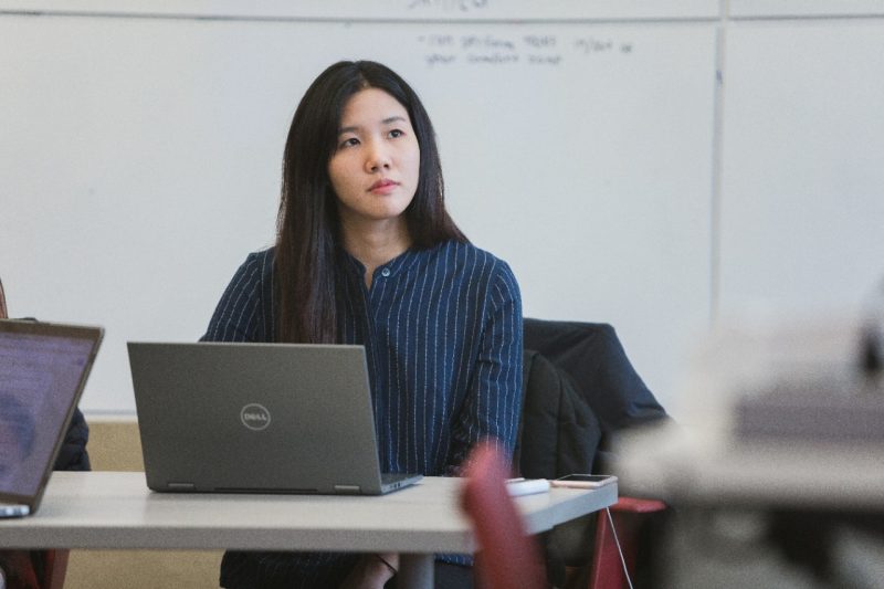Student listening to instructor in ACIS 4414.