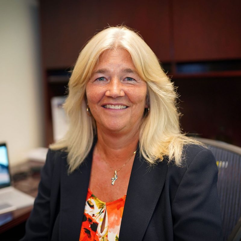 Headshot of Lisa Finneran at her desk