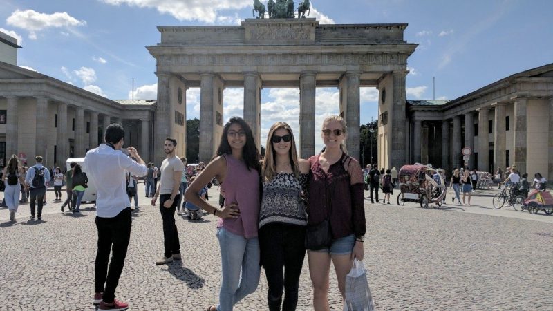 Three Virginia Tech students standing in outdoor courtyard in Paris.