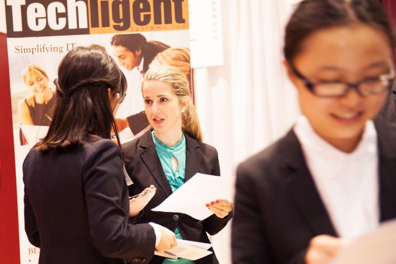 Female grad students at a career fair.