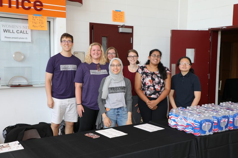 students standing in front of water bottles