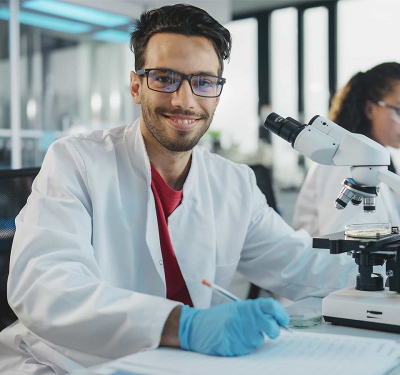 Student in a lab working on a microscope