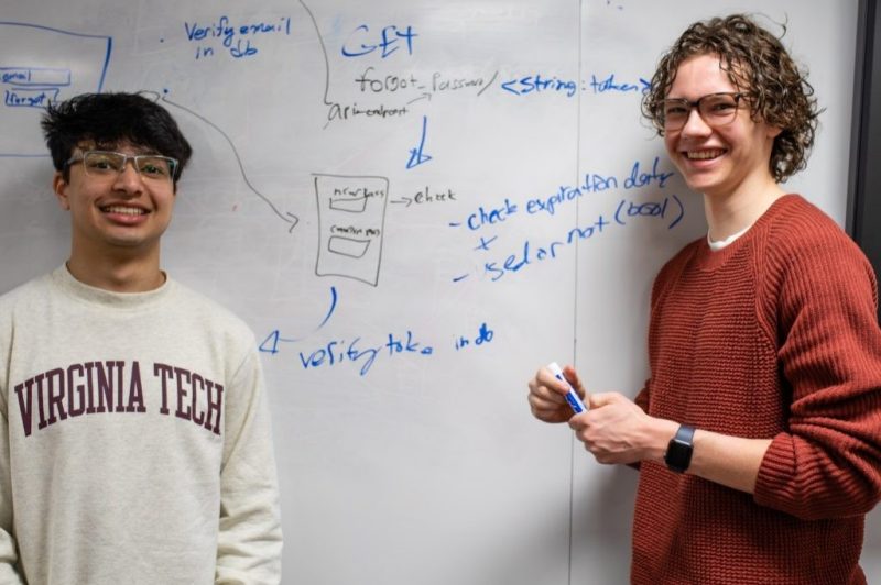 Two students in front of a whiteboard