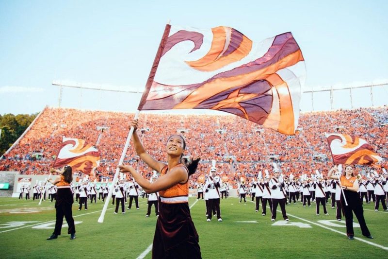 Julia Pimental twirls a flag in Lane Stadium