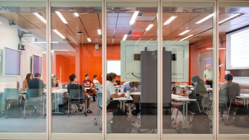 Looking into a classroom through a glass wall.