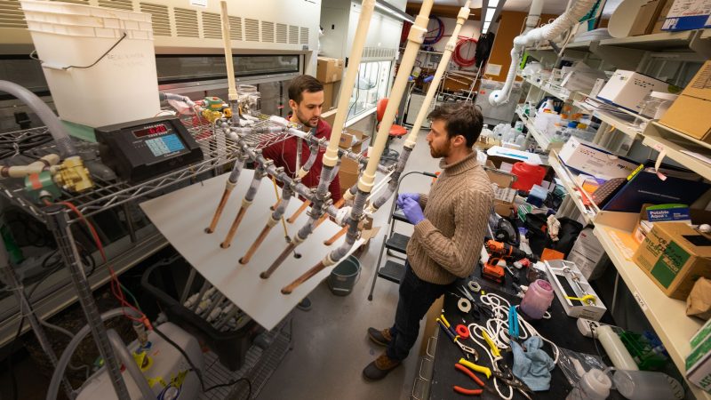 Two graduate students work on a legionella experiment in Amy Prudent's lab