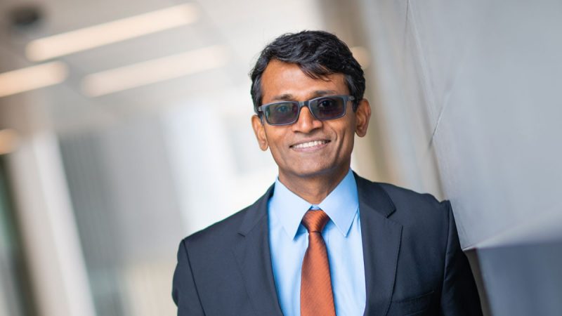 Suneel Kodambaka posing outside of Holden Hall