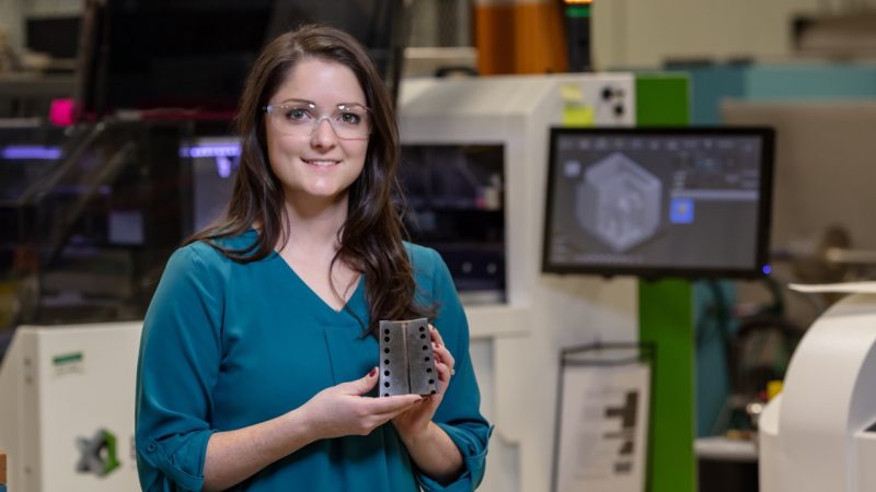 Amy Elliott posing and holding a tool.