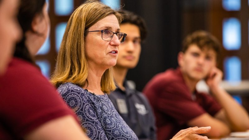 Dean Ross talks at a roundtable discussion with students.