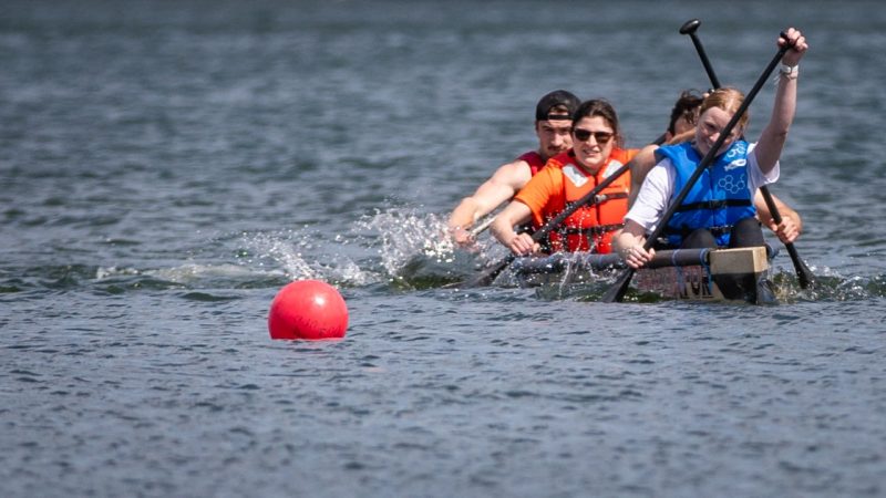 Concrete canoe team paddling on the water.