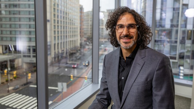 Steven Bathiche in an office interior with windows looking over Arlington, VA