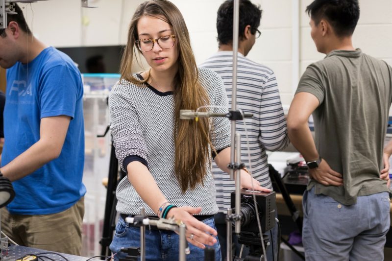 A graduate student sets up an experiment in the Jung Lab