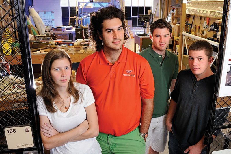 Four students posing in doorway of Ware lab bay 106