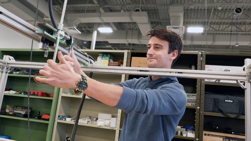 Ayden Cohn works in the lab of Yang Liu to adjust a device he built for measuring the size of water droplets in nuclear power applications. 