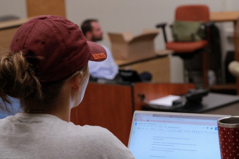 Woman wearing a Virginia Tech hat in class