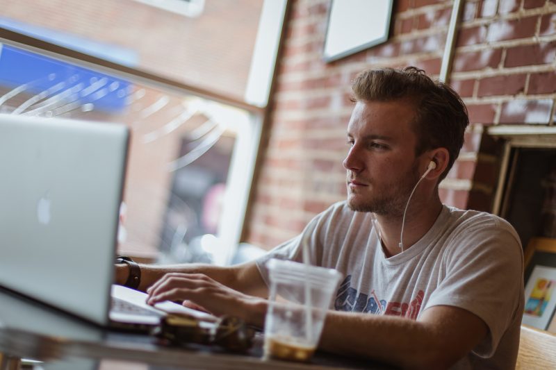 Student on laptop at cafe