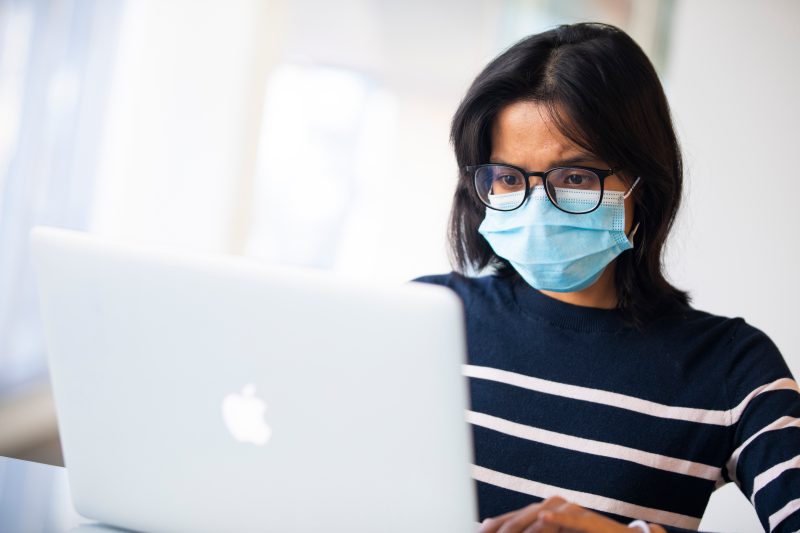 Woman in Mask at Computer